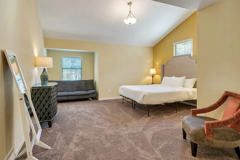 A suite with a seating area and a writing desk
